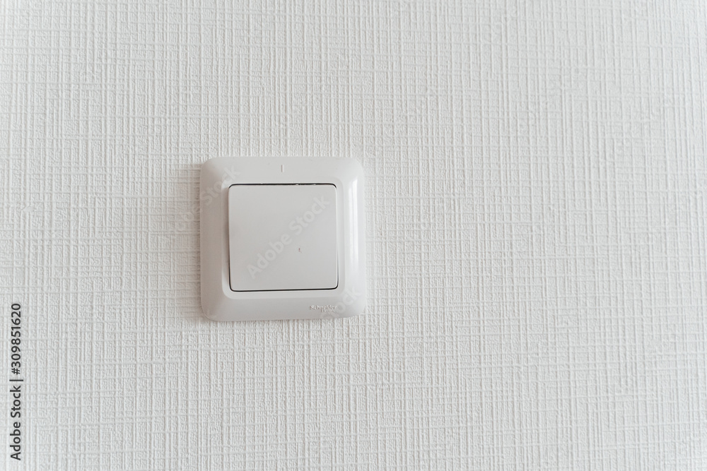White switch on the wall closeup White switch on the wall closeup