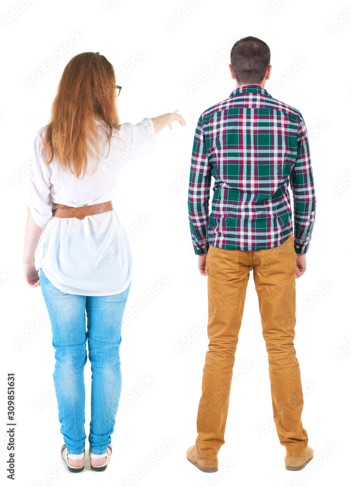 Back view of a stylish couple pointing. Back view of a stylish couple pointing.