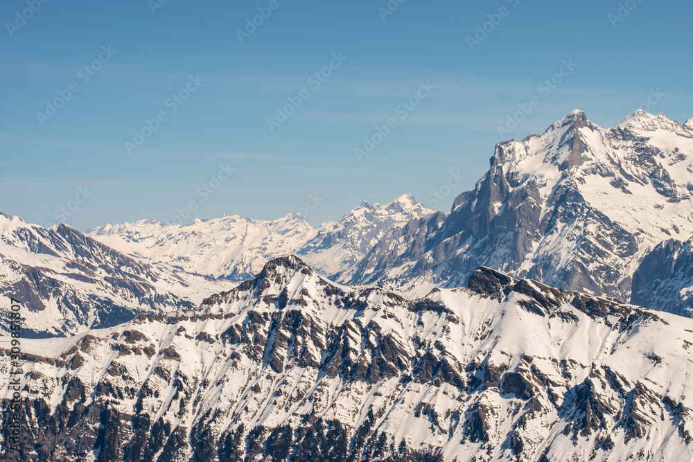 Swiss mountain peak after snowfall with panoramic view of Murren Jungfrau ski region.