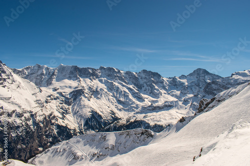 Swiss mountain peak after snowfall with panoramic view of Murren Jungfrau ski region.