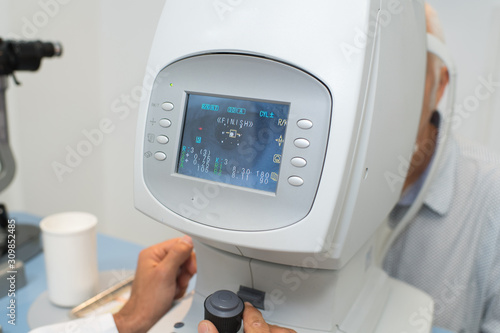 women looking at eye test machine in ophthalmology clinic