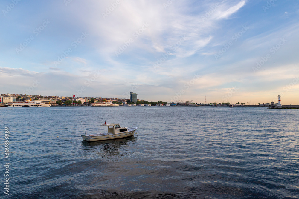 Dramatic sunset over dock in Istanbul with boat Dramatic sunset over dock in Istanbul with boat