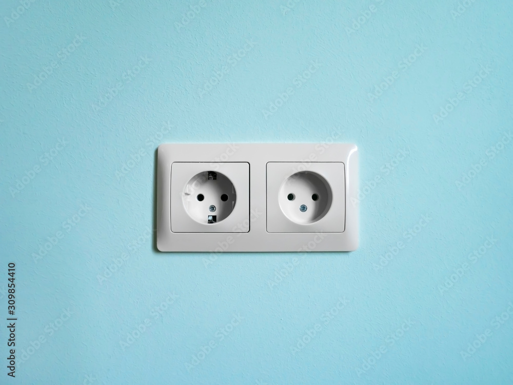 Electric double socket on the aquamarine wall. Electric double socket on the aquamarine wall.