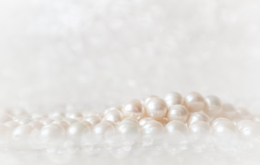 Nature white string of pearls on a sparkling background in soft focus, with highlights