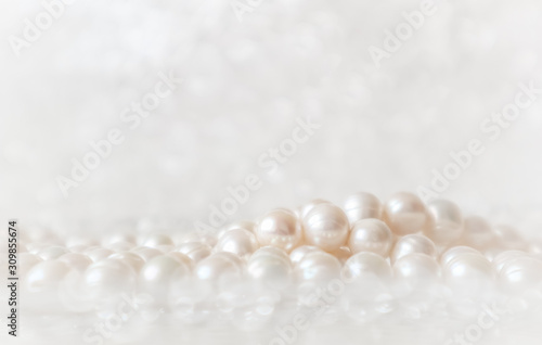 Nature white string of pearls on a sparkling background in soft focus, with highlights photo
