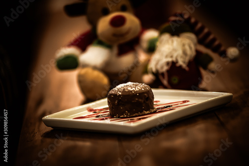 Christmas sweets in rustic cafeteria environment. Typical South American sweet known as gingerbread. Christmas decoration with chocolate candy.