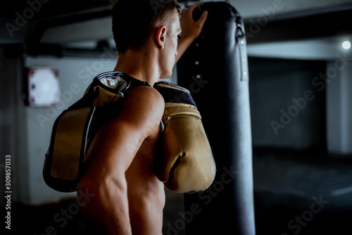 Sportive fighter resting from boxing training