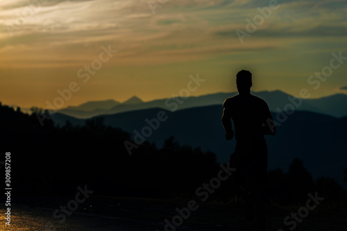Silhouette man working out while training run exercise © qunica.com