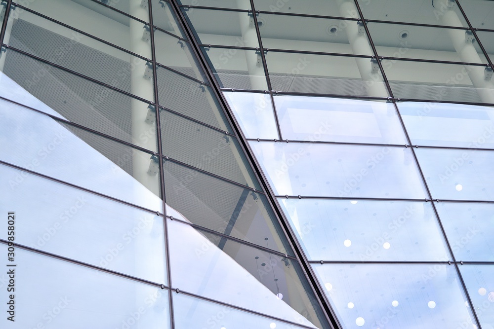Abstract image of looking up at modern glass and concrete building. Architectural exterior detail of office building. Abstract image of looking up at modern glass and concrete building. Architectural exterior detail of office building.