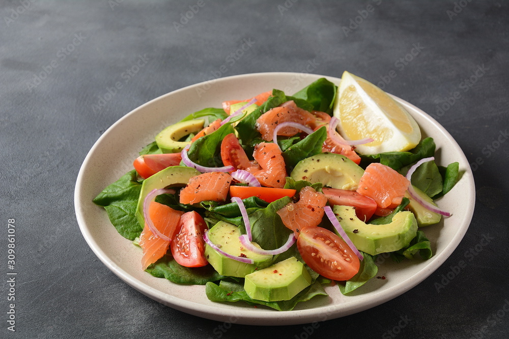 Mediterranean Avocado Salmon Salad with spinach, cherry tomatoes, avocado and red onion dressing. Concept for a tasty and healthy meal. Vegan food Mediterranean Avocado Salmon Salad with spinach, cherry tomatoes, avocado and red onion dressing. Concept for a tasty and healthy meal. Vegan food