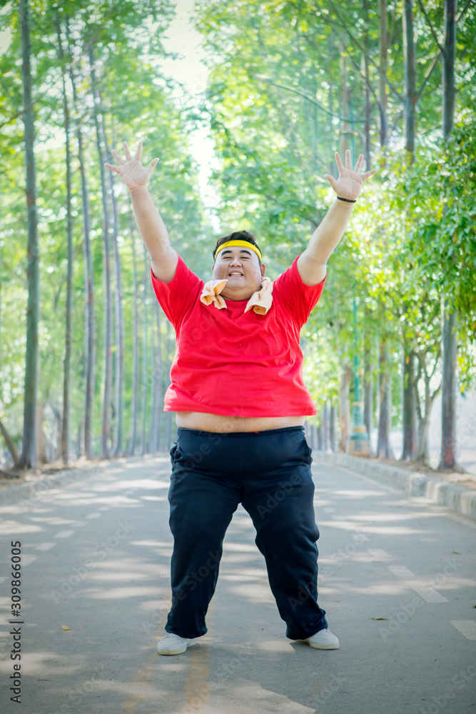 Fat Asian man raising his arms wide open