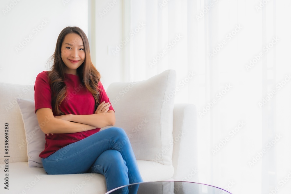 Portrait beautiful young asian women happy smile sit on sofa