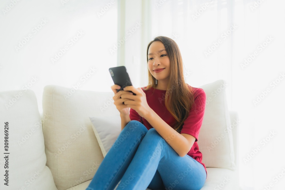 Portrait beautiful young asian women using mobile or smart phone on sofa Portrait beautiful young asian women using mobile or smart phone on sofa