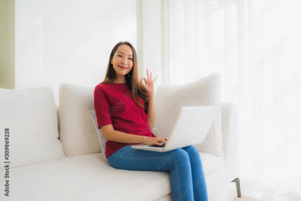 Portrait beautiful young asian women using computer laptop on sofa chair Portrait beautiful young asian women using computer laptop on sofa chair
