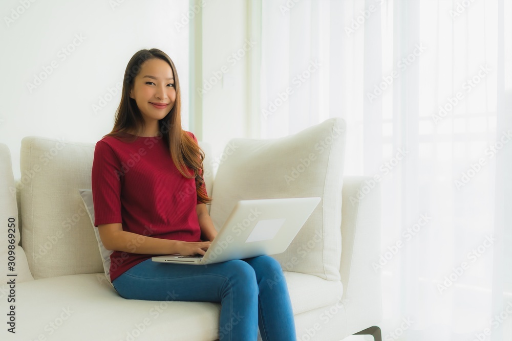 Portrait beautiful young asian women using computer laptop on sofa chair Portrait beautiful young asian women using computer laptop on sofa chair