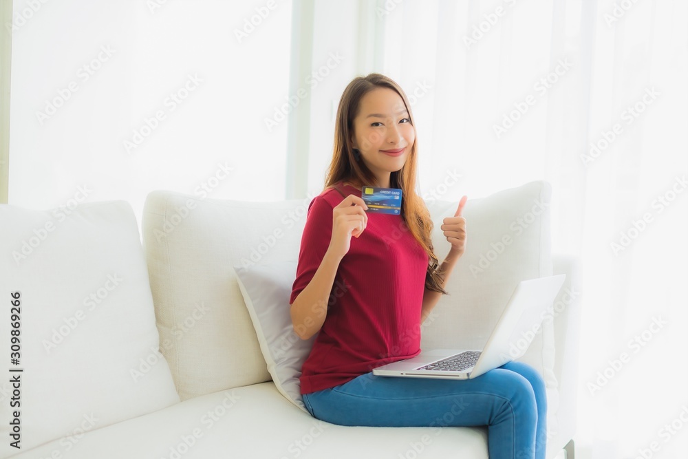 Portrait beautiful young asian women using computer laptop with mobile phone and credit card Portrait beautiful young asian women using computer laptop with mobile phone and credit card