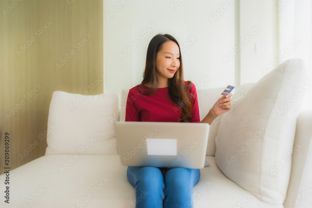 Portrait beautiful young asian women using computer laptop with mobile phone and credit card