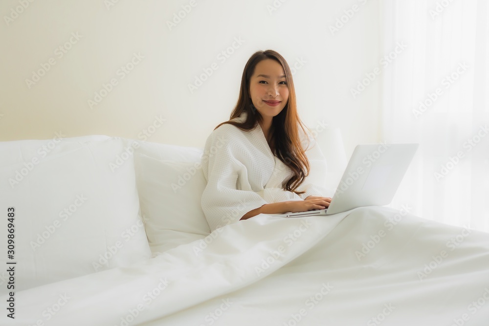 Portrait beautiful young asian women with coffee cup and computer laptop on bed Portrait beautiful young asian women with coffee cup and computer laptop on bed