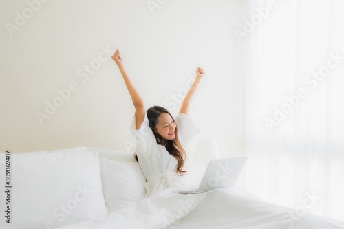 Wallpaper Mural Portrait beautiful young asian women with coffee cup and computer laptop on bed Torontodigital.ca