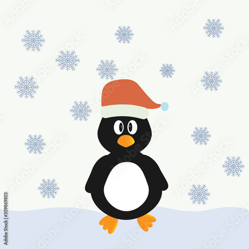 A little penguin in a Christmas hat stands in the snow © Елена  Барская