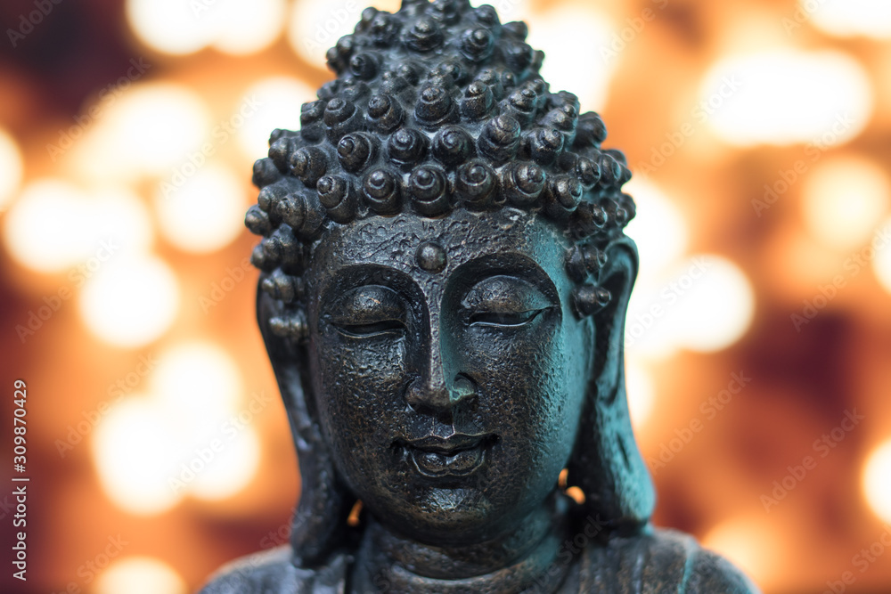 Buddha head in bronze with lights background Buddha head in bronze with lights background
