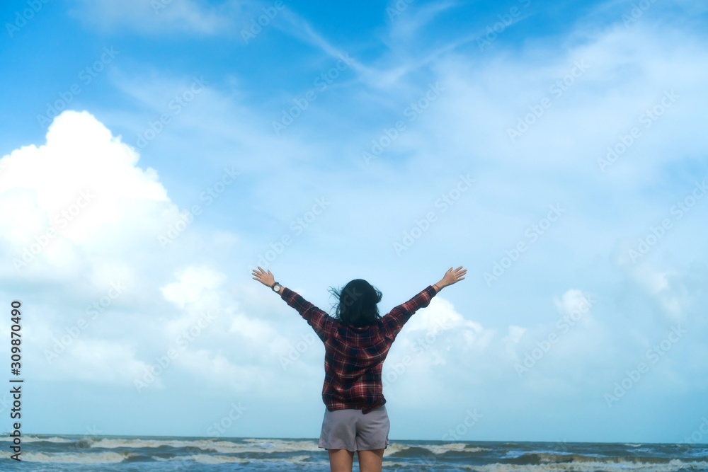 Woman rise hands up to sky freedom concept with blue sky. Woman rise hands up to sky freedom concept with blue sky.