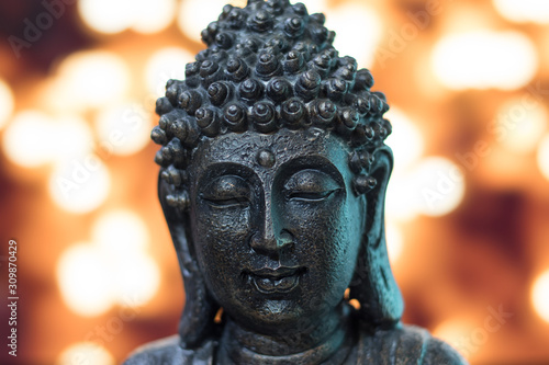 Buddha head in bronze with lights background © Karlos Montealban