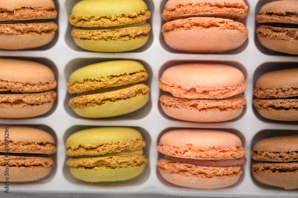 assortment of multi-colored french macaroons, delicious sweets. Background, top view