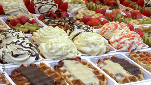 close up of belgian waffles on display at a bakery in brussels