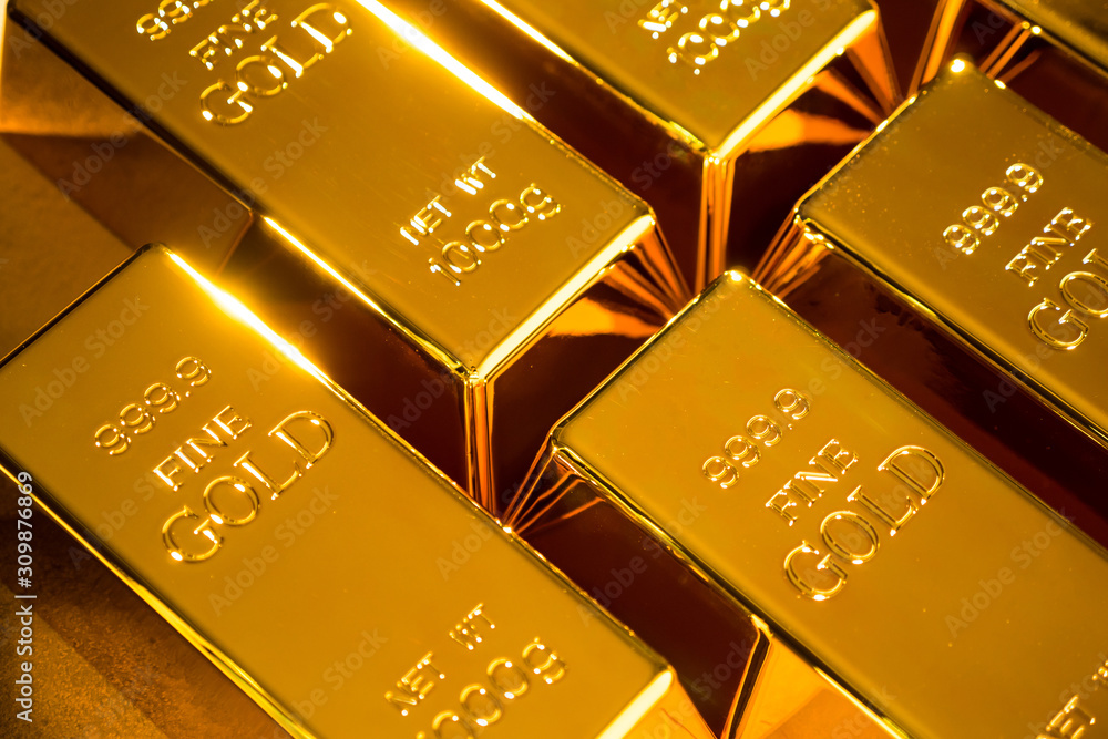 Shiny fine gold bullions on a gold background. Shiny fine gold bullions on a gold background.