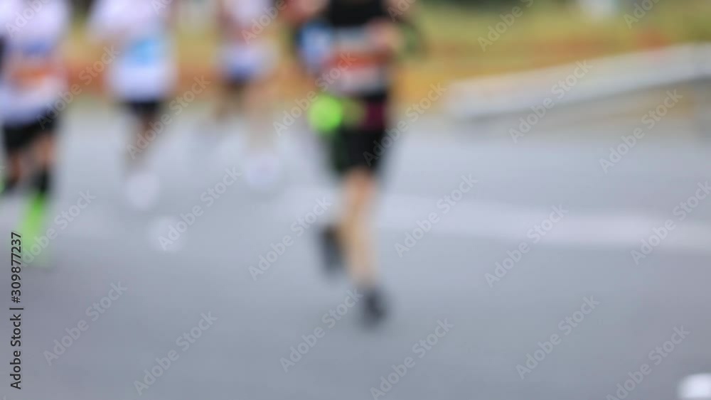 Defocused marathon runners running on the race. Defocused marathon runners running on the race.
