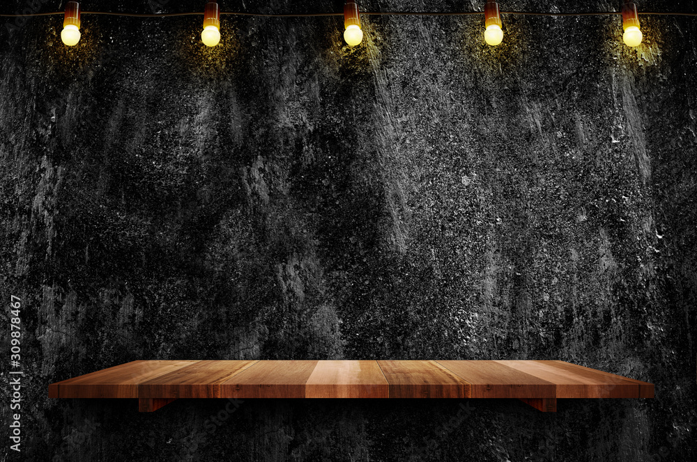 Empty brown plank wood shelf at black grung concerte wall background with light bulbs string,Mockup for display or montage of product or design - obrazy, fototapety, plakaty 