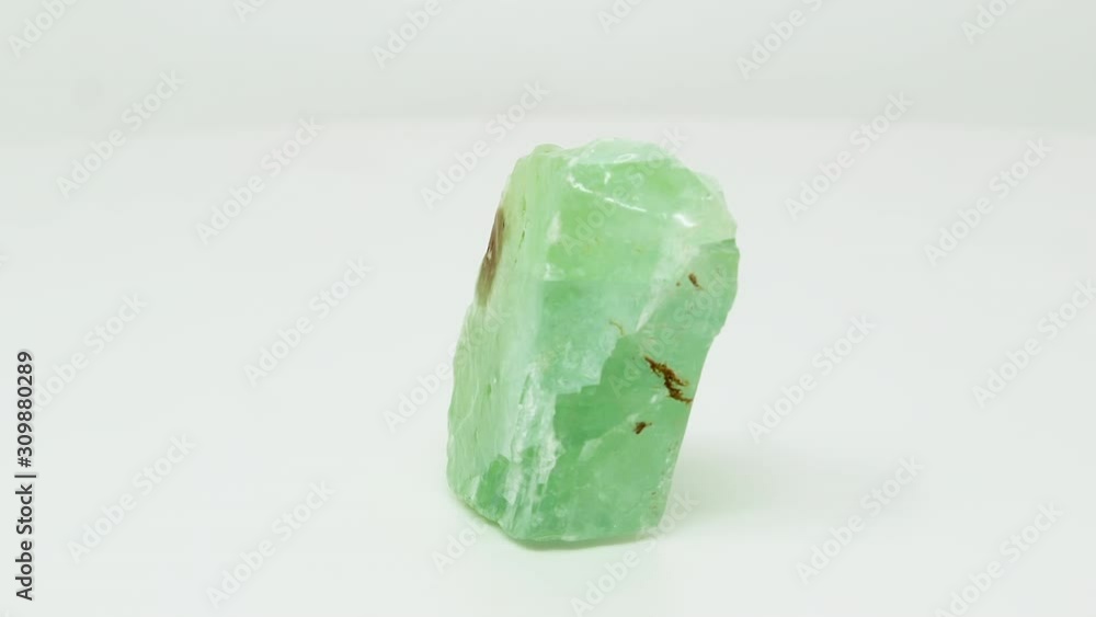Very close view of raw, green calcite mineral chunk. Rotating completely. Looping Very close view of raw, green calcite mineral chunk. Rotating completely. Looping
