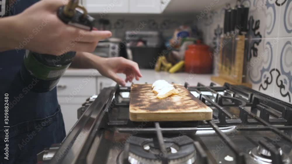 Slow motion capture of Japanese mayo coated salmon sushi being torched for a home meal. Slow motion capture of Japanese mayo coated salmon sushi being torched for a home meal.