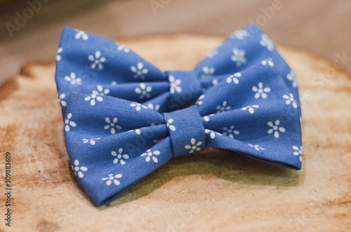 Blue bow tie isolated on wood background. Classic Blue color. Color of the year 2020. Trendy color