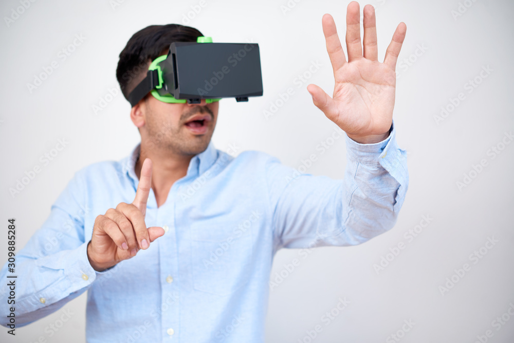 Excited businessman doing hand gestures when working in virtual reality headset Excited businessman doing hand gestures when working in virtual reality headset