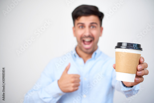Cup of hot morning coffee in hand of excited happy entrepreneur