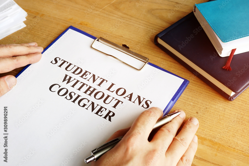 Man holding student loans without cosigner application form. Man holding student loans without cosigner application form.