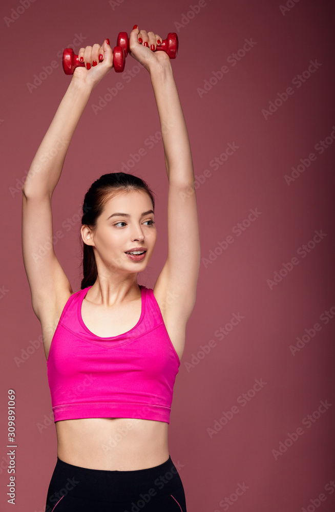 Studio shot of brunette caucasian woman doing sports. Studio shot of brunette caucasian woman doing sports.