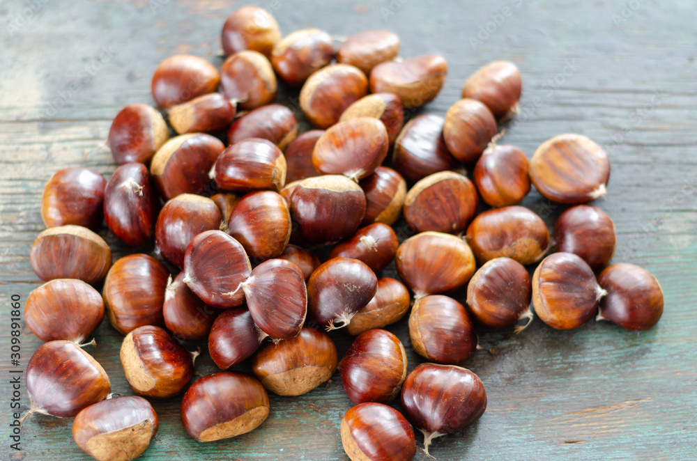 Edible chestnuts on the  wooden table.