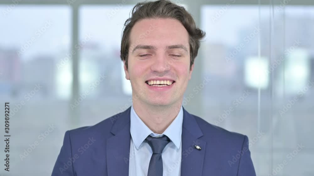 Portrait of Cheerful Young Businessman Waving at the Camera Portrait of Cheerful Young Businessman Waving at the Camera