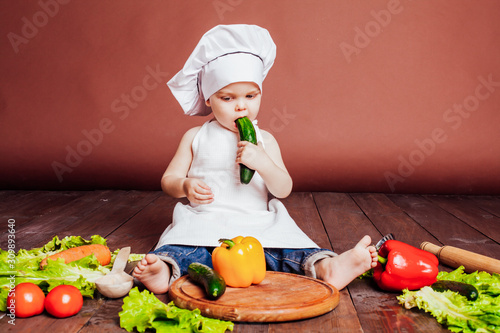 little boy Cook carrots, peppers, tomatoes, lettuce, photo