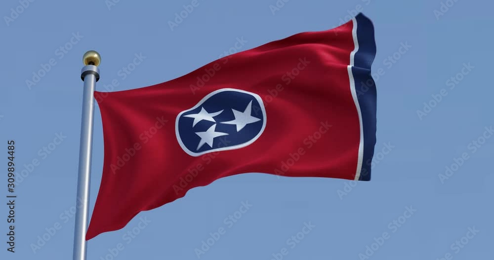 flag of Tennessee blowing in the wind in front of a blue sky flag of Tennessee blowing in the wind in front of a blue sky