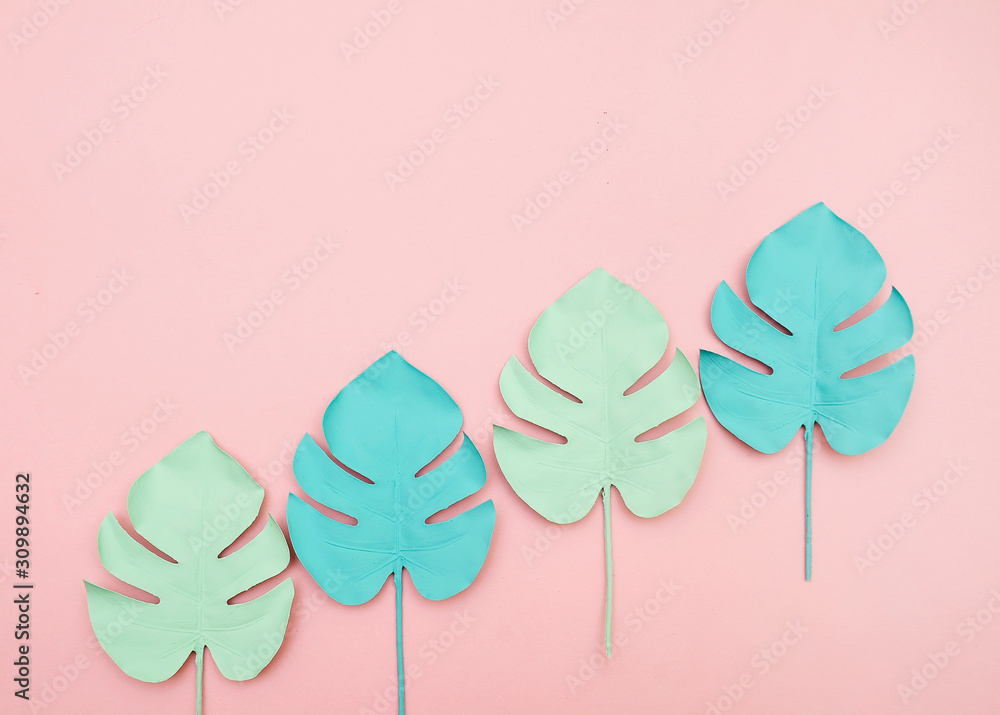 Monstera leaves on pink background.
