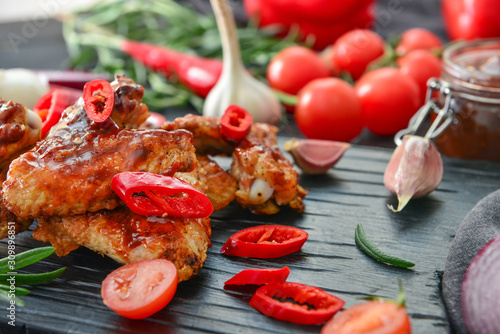 Fototapeta Naklejka Na Ścianę i Meble -  Tasty chicken wings with barbecue sauce on table