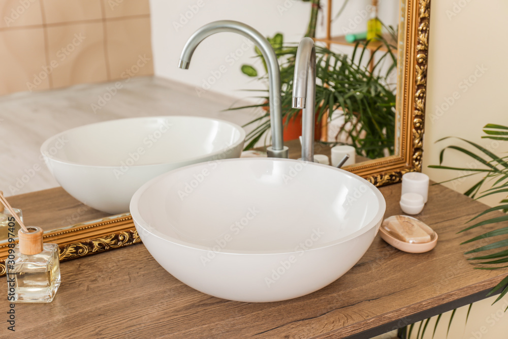 Interior of clean bathroom with sink near mirror Interior of clean bathroom with sink near mirror