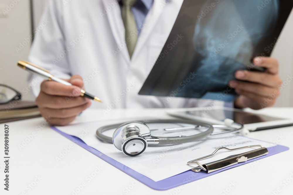 Fototapeta premium Healthcare and medical concept, Doctor looking head x-ray film in office.