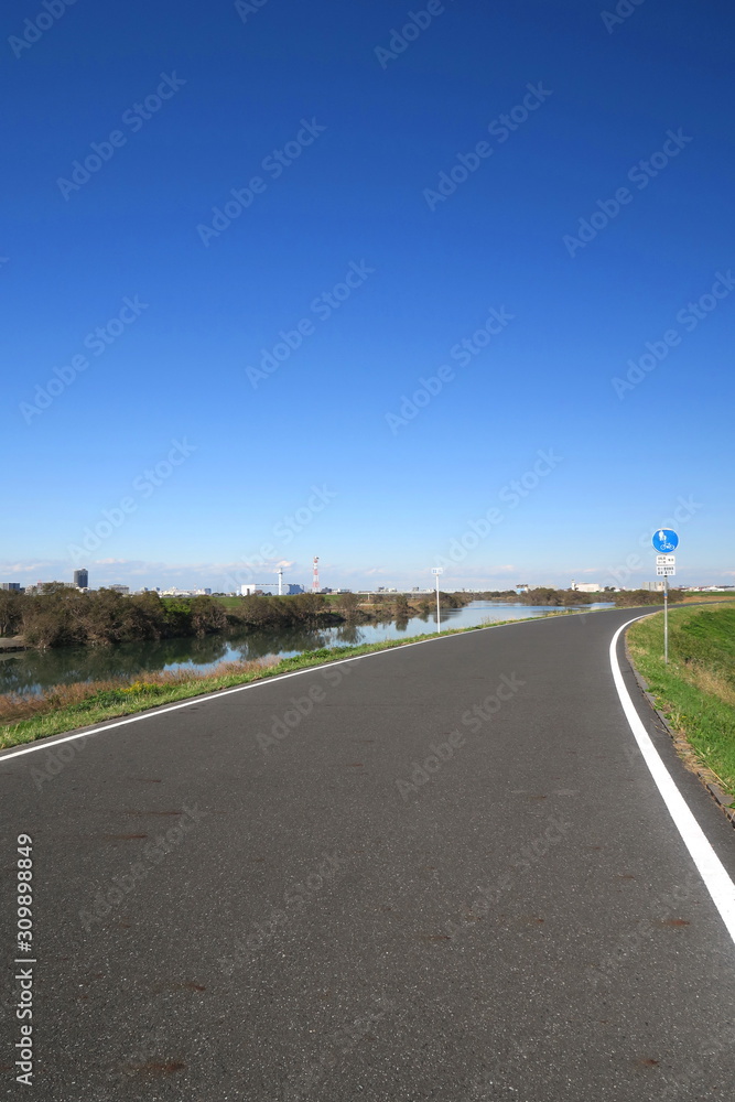 Fototapeta premium 冬の江戸川サイクリング道路と青空風景