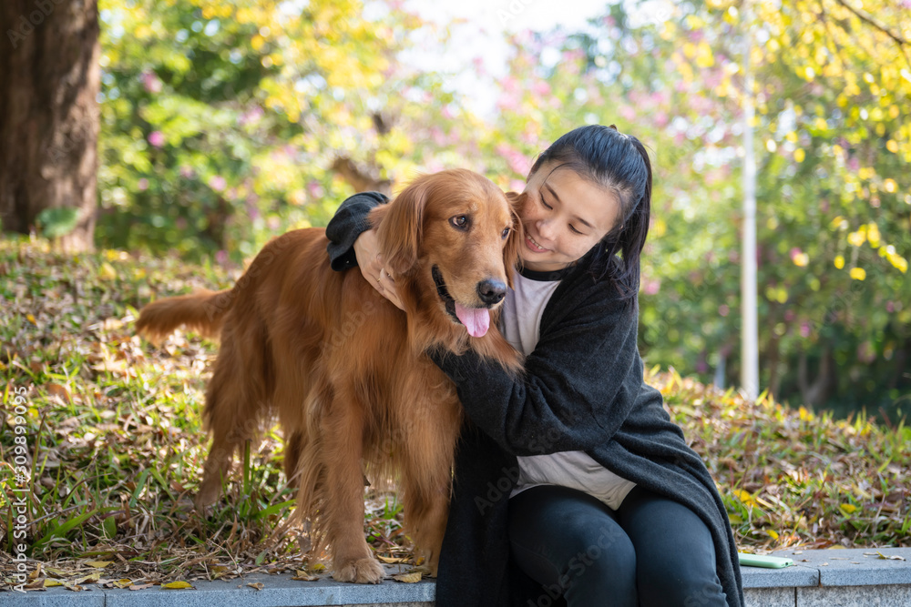 The woman and her golden retrieval dog are friendly.