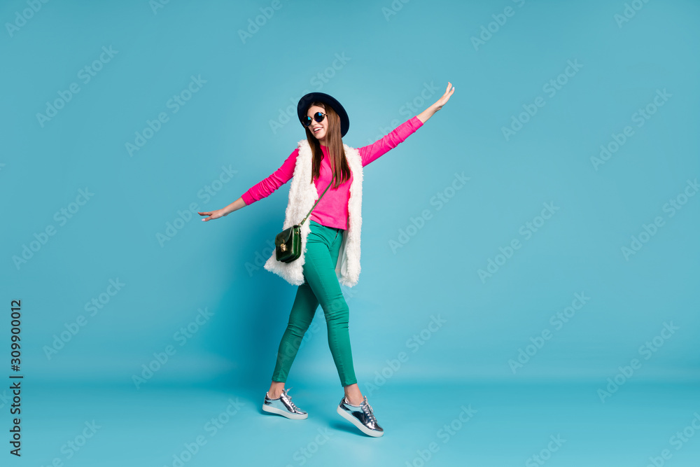 Full length body size view of her she nice attractive dreamy cheerful cheery funny funky girl strolling having fun isolated on bright vivid shine vibrant green blue turquoise color background